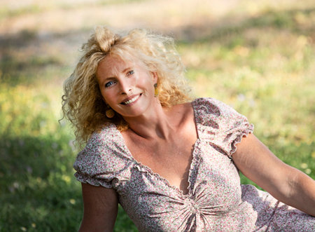 beautiful young woman standing in a gardenの写真素材