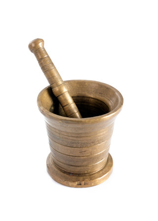 brass mortar in front of white backgroundの写真素材