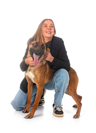 belgian shepherd and owner in front of white background