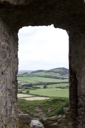 Window of ancient castle ruins in remote Ireland looking out onto the Irish countrysideの写真素材