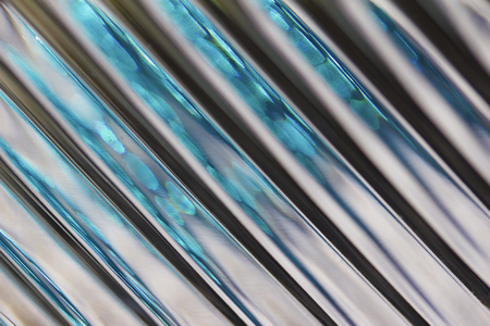Macro abstract art background of defocused lead crystal glass with diagonal lines giving a silver metallic lookの写真素材