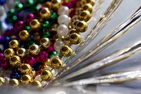 Macro abstract art texture of beautiful lead crystal glass with curved rippling surface and multi color metallic beads, reflecting brilliant light and colorの写真素材