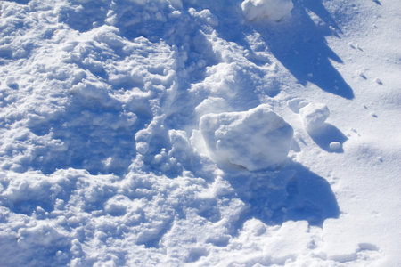 Close up view of lumpy snow texture on a sunny day