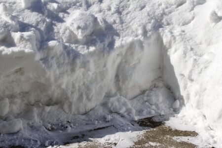 Close up view of a deep bank of snow from a snow blower after a blizzardの写真素材