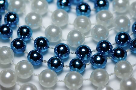 Close up abstract texture background of metallic blue and white beads on white backgroundの写真素材