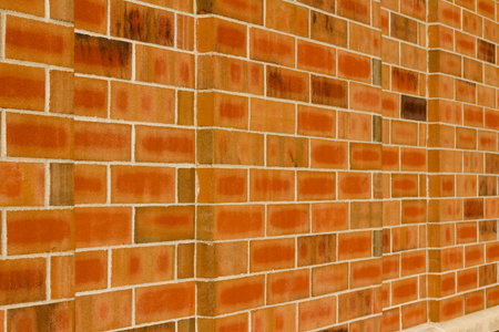 Vintage orange color brick wall texture background in 1/3 offset stagger brickwork pattern
