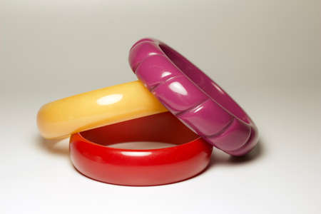 Close up view of vintage bakelite (baekelite) bangle braceltets on white background, with copy spaceの写真素材