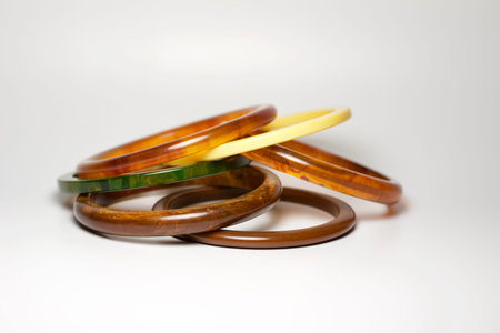 Close up view of vintage bakelite (baekelite) bangle braceltets on white background, with copy space