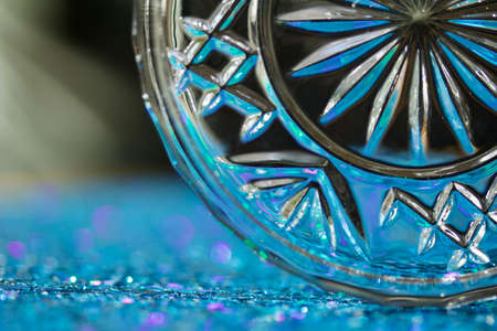 Macro art abstract background of beautiful round crystal glass texture reflecting blue and green color and bokehの写真素材