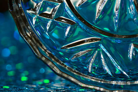 Macro art abstract background of beautiful round crystal glass texture reflecting blue and green color and bokehの写真素材
