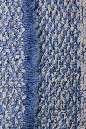 Macro art abstract background of a vintage blue and white cotton fabric towel texture with fringe