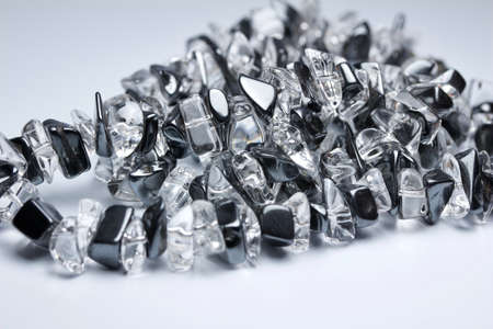 Macro abstract texture view of a chunky vintage hematite and quarts necklace with natural stones, on a white background with copy spaceの写真素材