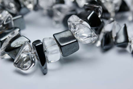 Macro abstract texture view of a chunky vintage hematite and quarts necklace with natural stones, on a white background with copy spaceの写真素材