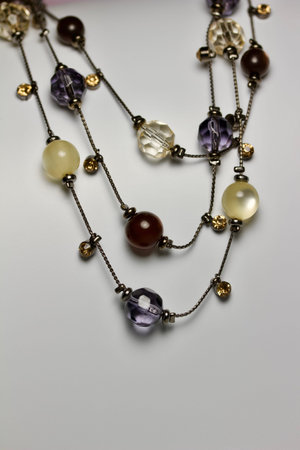 Vintage multi color necklace with glass beads, on white background with copy space