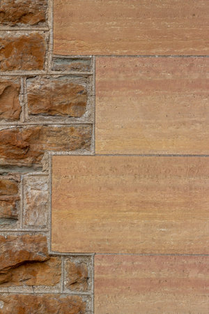 19th century tan color natural stone wall background with tuckpointing mortar restoration