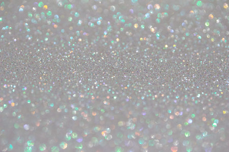 Shimmering white glitter texture background with bokeh