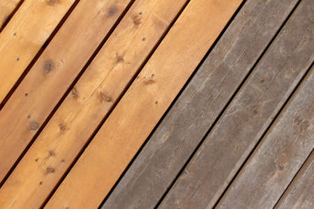 Close up abstract texture comparison view of new cedar wood deck flooring, next to older weathered cedar, with copy spaceの写真素材