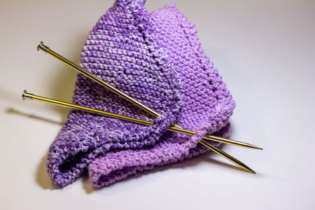 This image shows a macro abstract texture background of hand-knitted yarn cloth in a common garter...