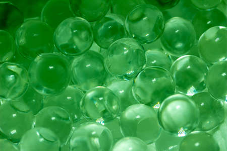 This image shows an abstract macro texture background of super absorbent polymer water gel beads with the appearance of wet round glass balls.の写真素材