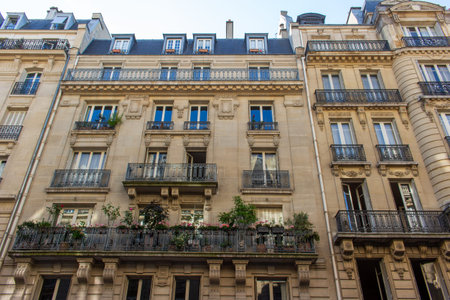 Close, upward exterior view of traditional building architecture in France, with stone walls and...