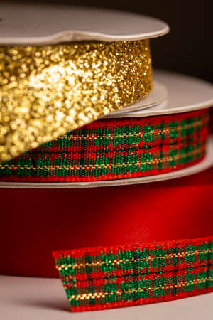 This image shows a macro abstract texture background of assorted colorful  Christmas holiday fabric ribbons with copy space.の写真素材