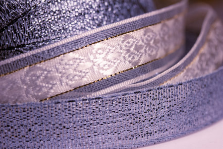 Full frame macro abstract texture background of shimmering fabric and metallic ribbon in a lovely shade of lavender blueの写真素材