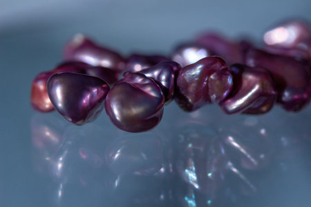 Macro abstract texture background of a deep pink color natural baroque pearl necklace with natural...