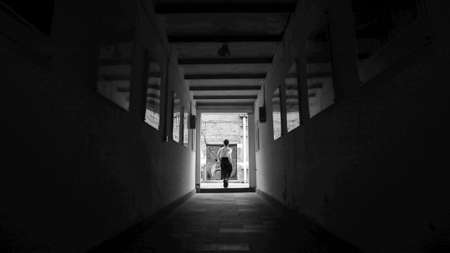 woman walking out from  the darkの写真素材