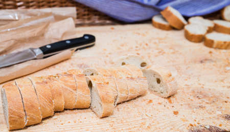 Sliced bread on wood texture with knife and crumbsの写真素材