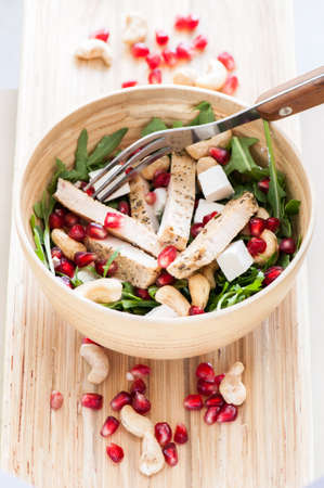 Delicious rucola salad with turkey and pomegranateの写真素材