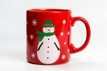 Red christmas tea mug with snowman on white backgroundの写真素材