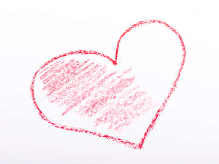 Closeup of a red pencil drawing a heart. On white paper.の写真素材