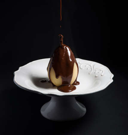 Pear Poached with Chocolate sauceの写真素材