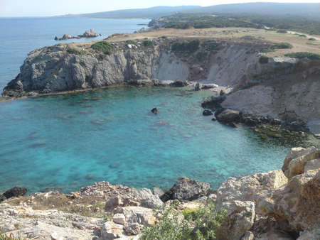 Beautiful small cove, aqua coloured sea rocky hills.の写真素材