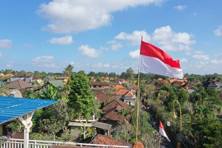 Indonesia flag flying high over the city of Ubudの写真素材