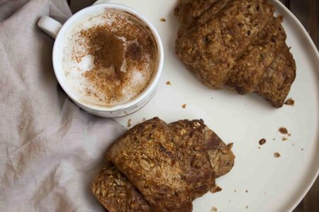 Delicious morning coffee with seeds croissants on white plate.の写真素材