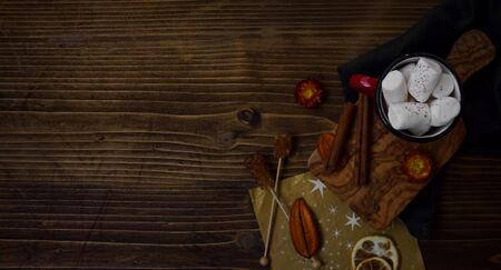 Background of hot chocolate with marshmallows and cinnamon on wooden background.の写真素材