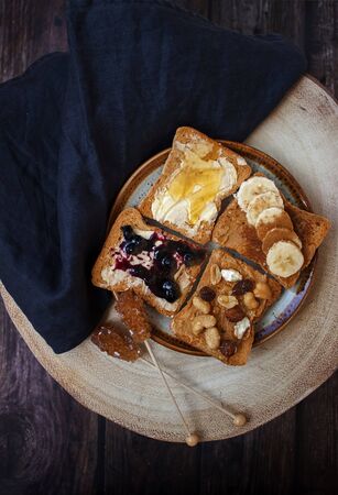 Healthy morning breakfast with different types of toast and brown sugar on rustic wooden background.の写真素材