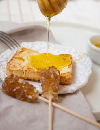 Close-up of delicious breakfast with honey glazed toast and vintage kitchen details.