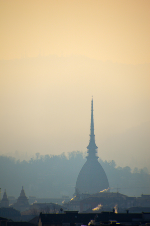 mole antonelliana, the most iconic building in Turin, Italy, silouetted against the hillsの写真素材
