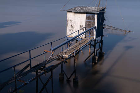 Typical old wooden fishing huts on stilts in the atlantic ocean in Saint-Nazaire in France.の写真素材