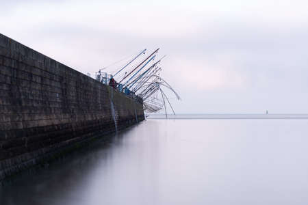 Typical old wooden fishing huts on stilts in the atlantic ocean in Saint-Nazaire in France.の写真素材