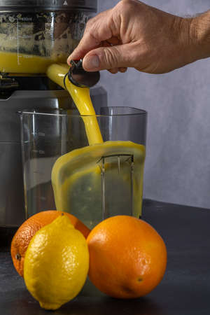 2021 December - photo shoot of an orange and lemon juice production using a juice extractor.の写真素材