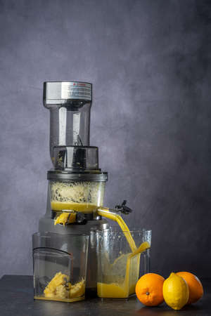 photo shoot of an orange and lemon juice production using a juice extractor.の写真素材