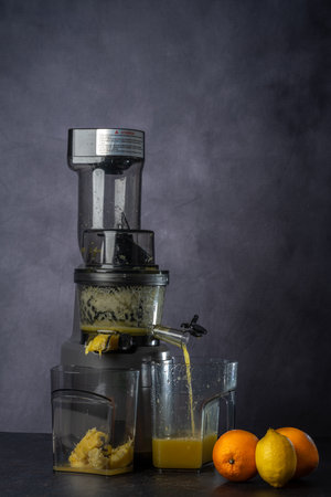photo shoot of an orange and lemon juice production using a juice extractor.の写真素材