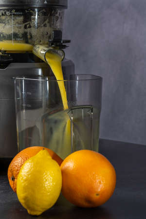 2021 December - photo shoot of an orange and lemon juice production using a juice extractor.の写真素材