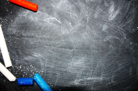 Black chalkboard for copy space with colorful pieces of chalk.の写真素材