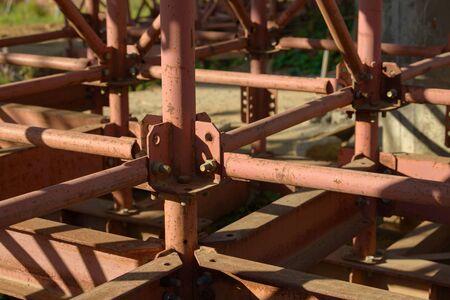 Scaffolding Elements Construction. Metal scaffolding tubes and bars. Construction site details. Bridge support.の写真素材