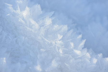 Hoarfrost background texture. Fresh ice and snow winter backdrop with snowflakes and mounds....