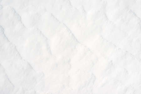 White snow texture background. Snowflakes on the surface of the snow.の写真素材